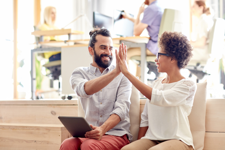 two-people-high-five-in-office